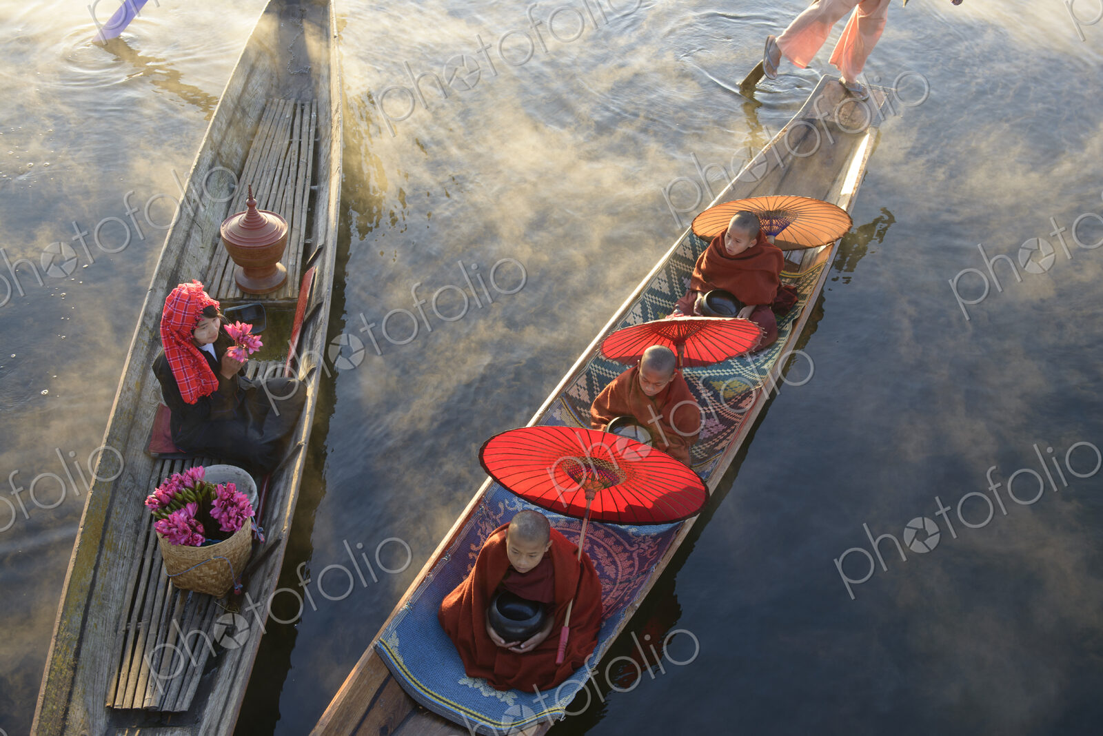 Asian gondoliers rowing canoes on river