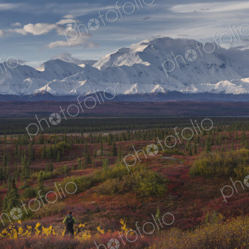 Asian hiker admiring scenic view of mountain range Asian hiker admiring scenic view of mountain range