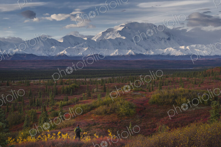 Asian hiker admiring scenic view of mountain range