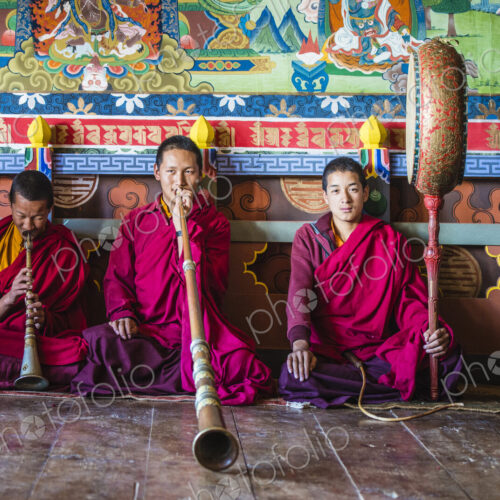 Asian monks playing instruments on temple floor Asian monks playing instruments on temple floor