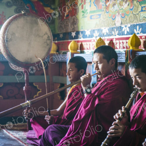 Asian monks playing instruments on temple floor Asian monks playing instruments on temple floor