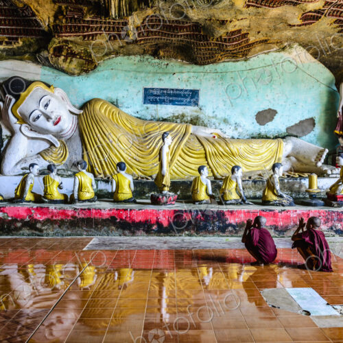 Asian monks praying to Buddha statue in temple Asian monks praying to Buddha statue in temple