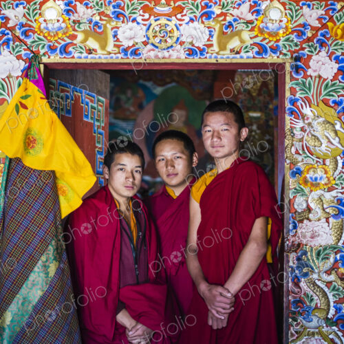 Asian monks standing in temple doorway Asian monks standing in temple doorway