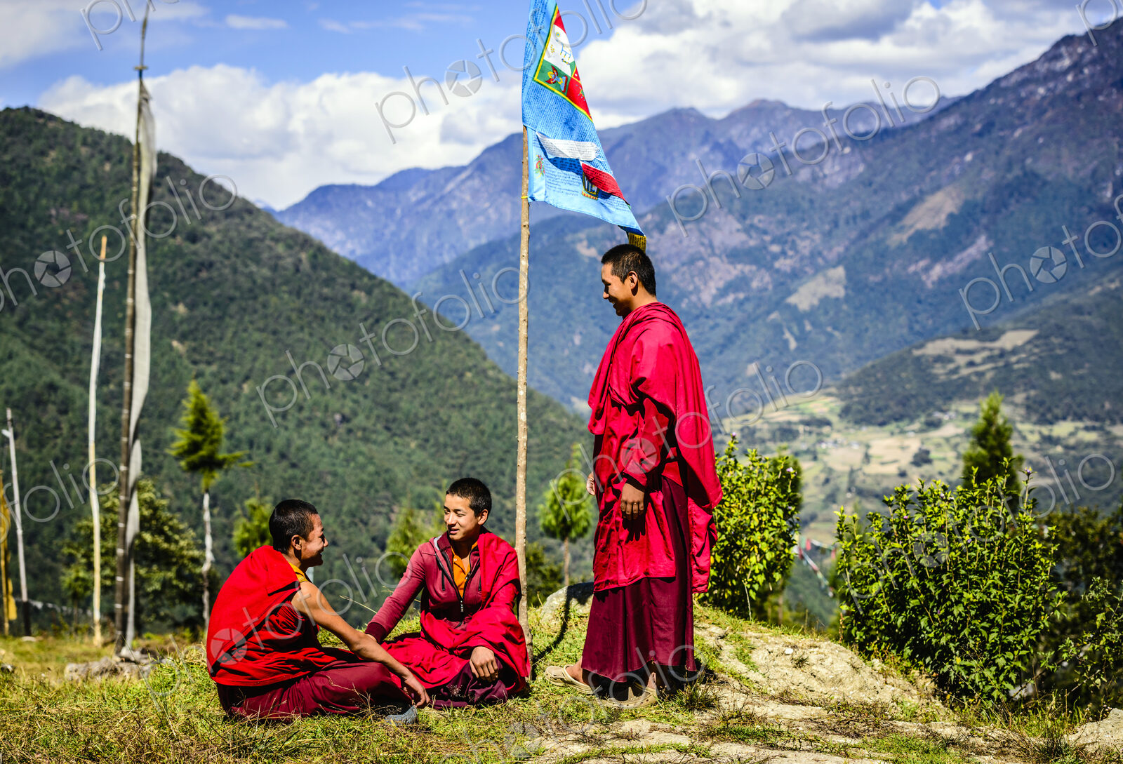 Asian monks with flag on remote hilltop
