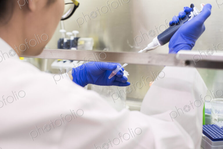 Asian scientist using pipette
