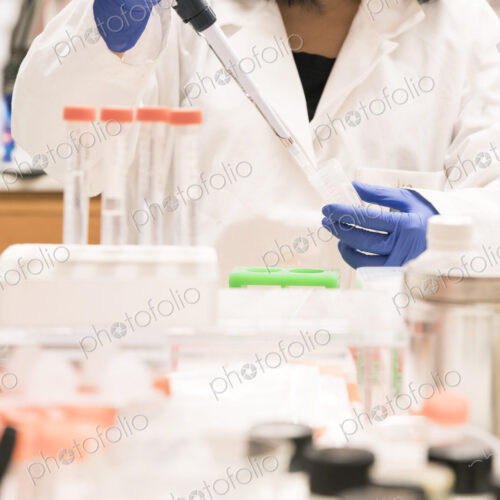 Asian scientist using pipette