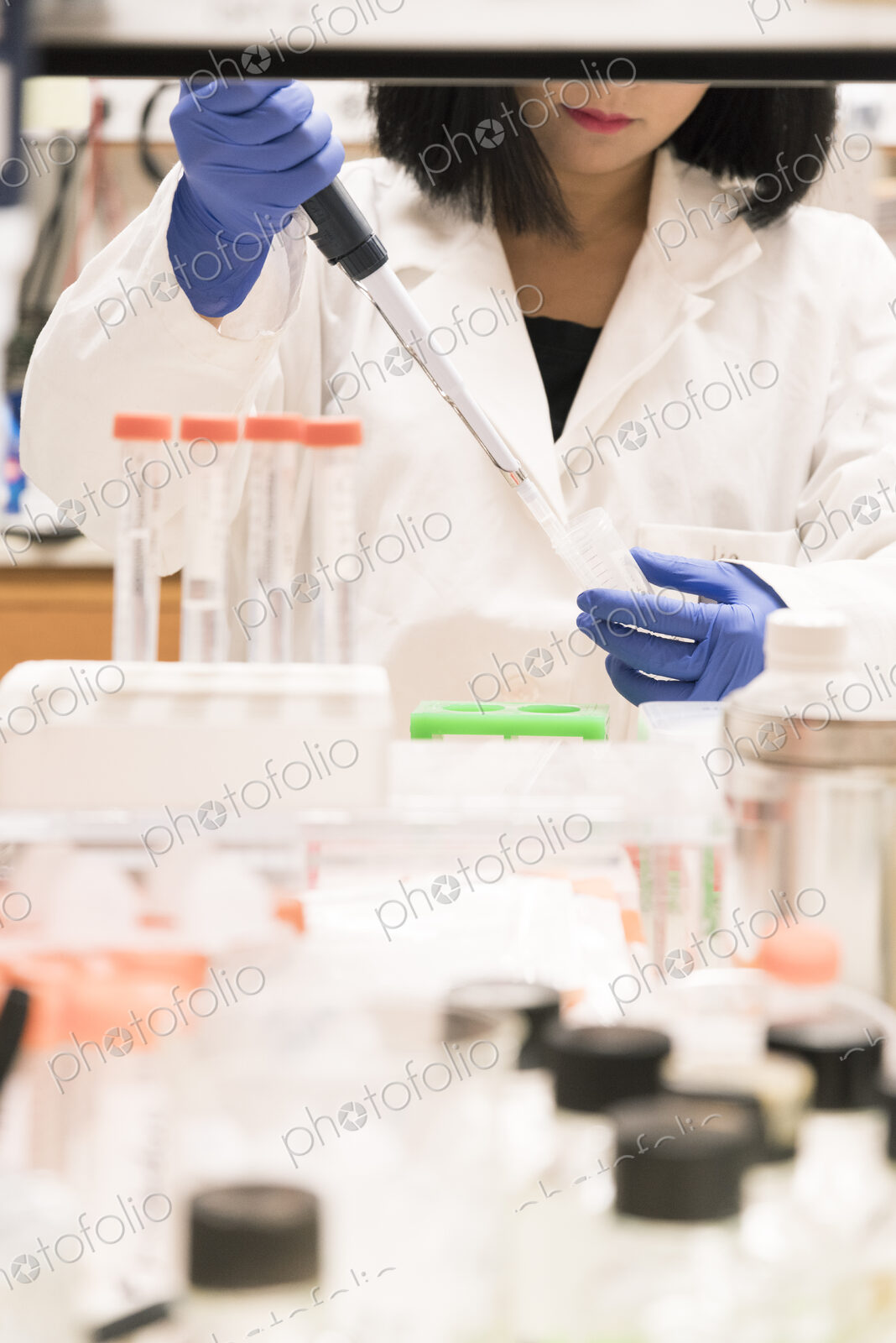 Asian scientist using pipette