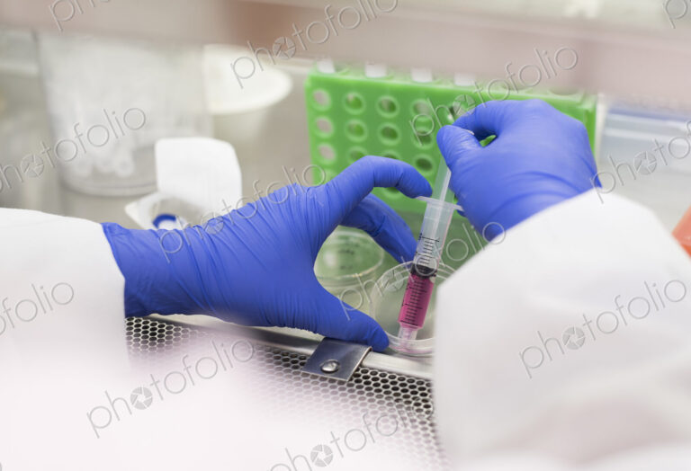 Asian scientist using syringe and petri dish