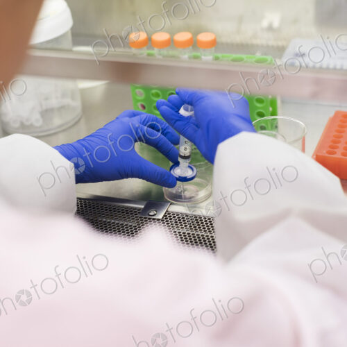 Asian scientist using syringe and petri dish