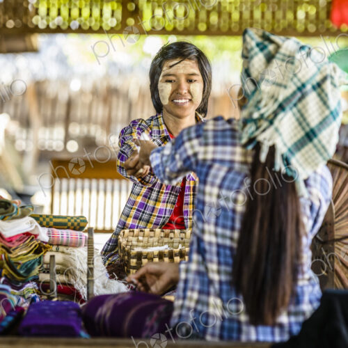 Asian teenage boy selling fabric at market Asian teenage boy selling fabric at market