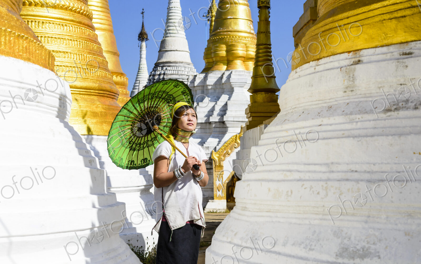 Asian woman carrying parasol at temple