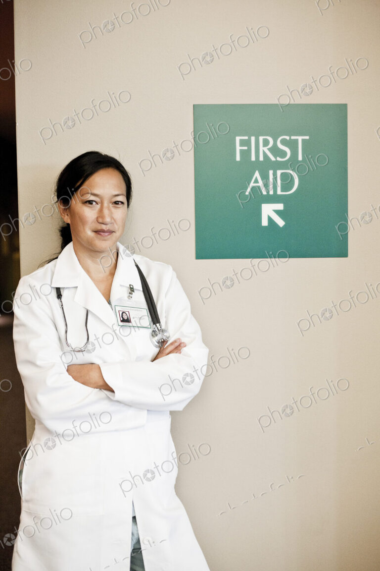 Asian woman doctor in lab coat with stethescope.