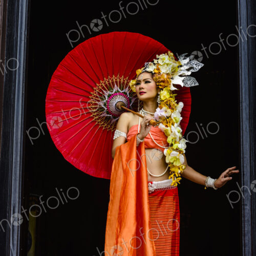 Asian woman standing in ornate temple doorway, Chiang Mai, Chiang Mai, Thailand Asian woman standing in ornate temple doorway, Chiang Mai, Chiang Mai, Thailand