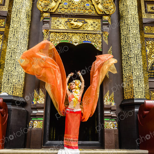 Asian woman standing on ornate temple stairs, Chiang Mai, Chiang Mai, Thailand Asian woman standing on ornate temple stairs, Chiang Mai, Chiang Mai, Thailand