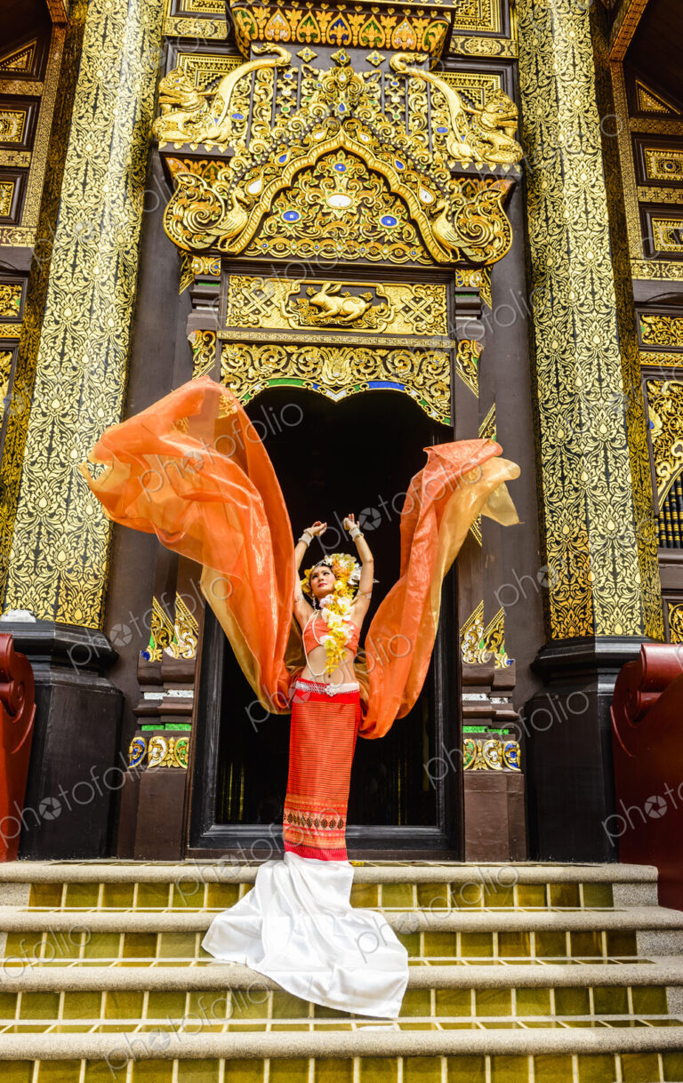Asian woman standing on ornate temple stairs, Chiang Mai, Chiang Mai, Thailand