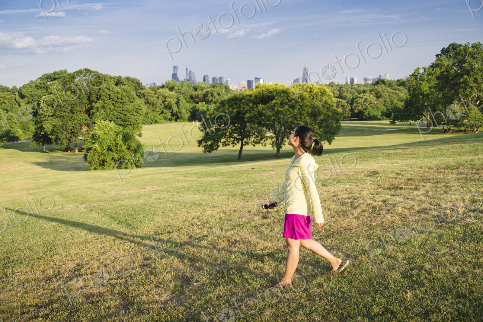 Asian woman walking in urban park