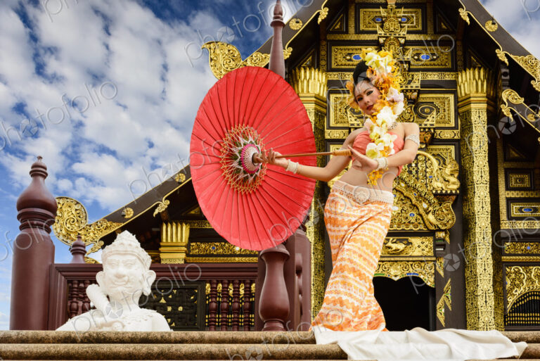 Asian woman with parasol on stairs of ornate Buddhist temple, Chiang Mai, Chiang Mai,…