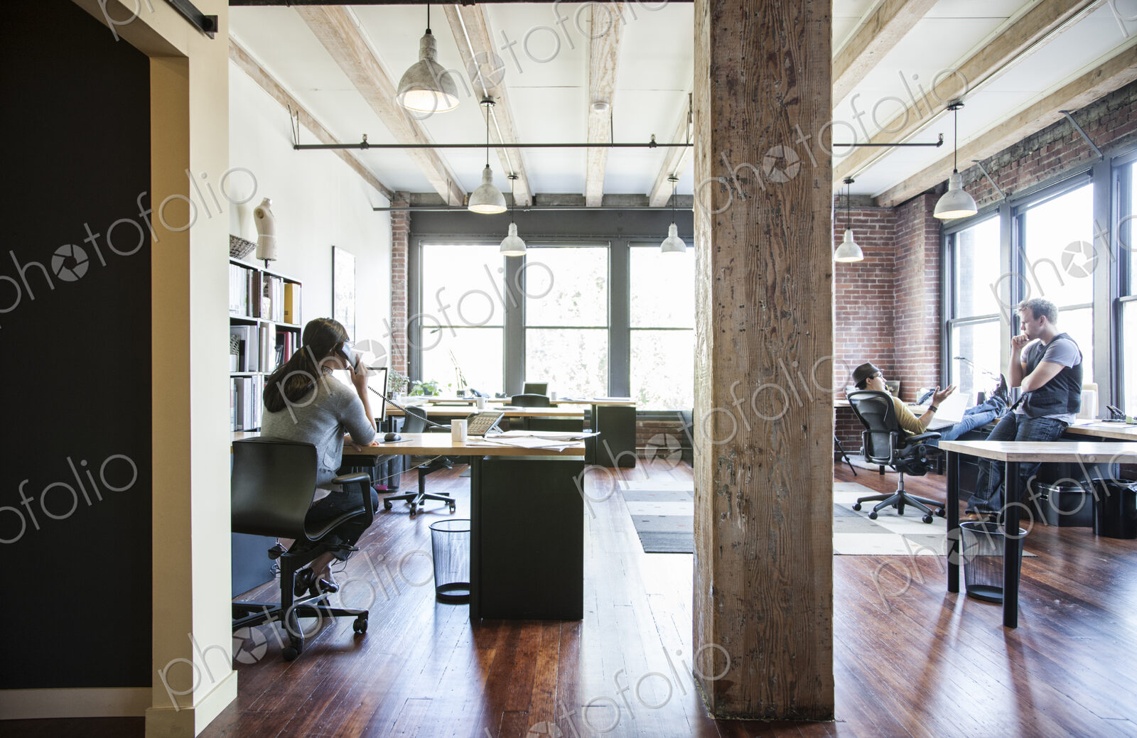 Asian woman working at her desk in a creative office.