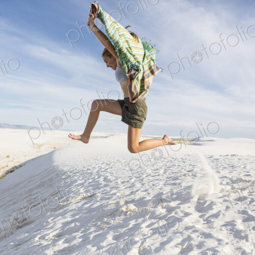 Athletic 13 year old girl leaping in the sand, White Sands Nat'l Monument, NM Athletic 13 year old girl leaping in the sand, White Sands Nat'l Monument, NM