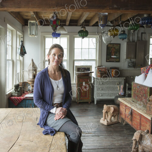 Awoman in an antique store in a small town, with objects and furniture from the past. Awoman in an antique store in a small town, with objects and furniture from the past.
