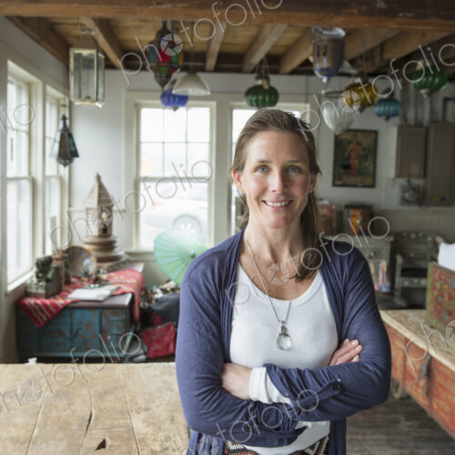 Awoman in an antique store in a small town, with objects and furniture from the past. Awoman in an antique store in a small town, with objects and furniture from the past.