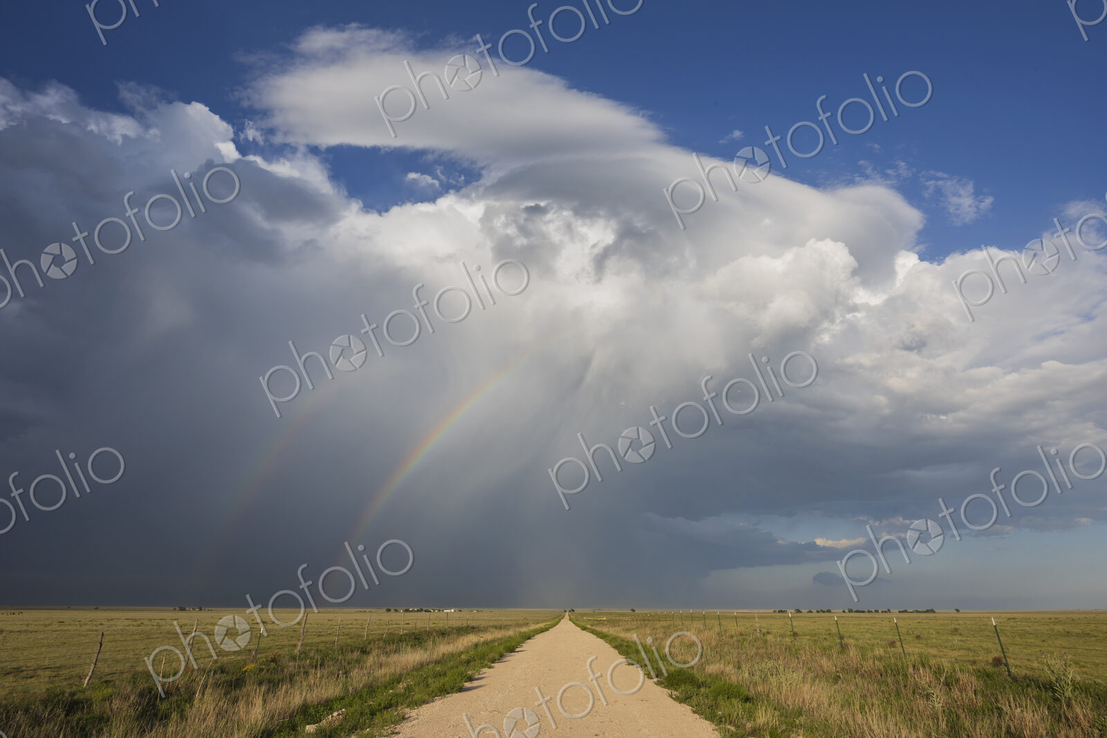 Back Side of a Supercell with a Double Rainbow;