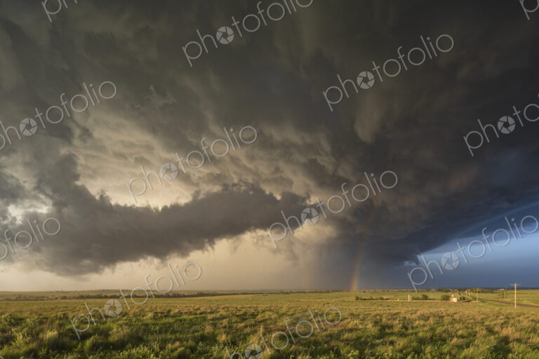 Back Side of a Tornado-Producing Supercell, black clouds, and blue sky on the horizon…