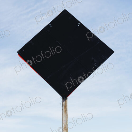 Back side of road sign, blue sky in background Back side of road sign, blue sky in background