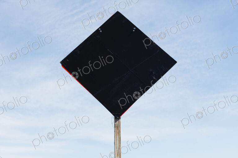 Back side of road sign, blue sky in background