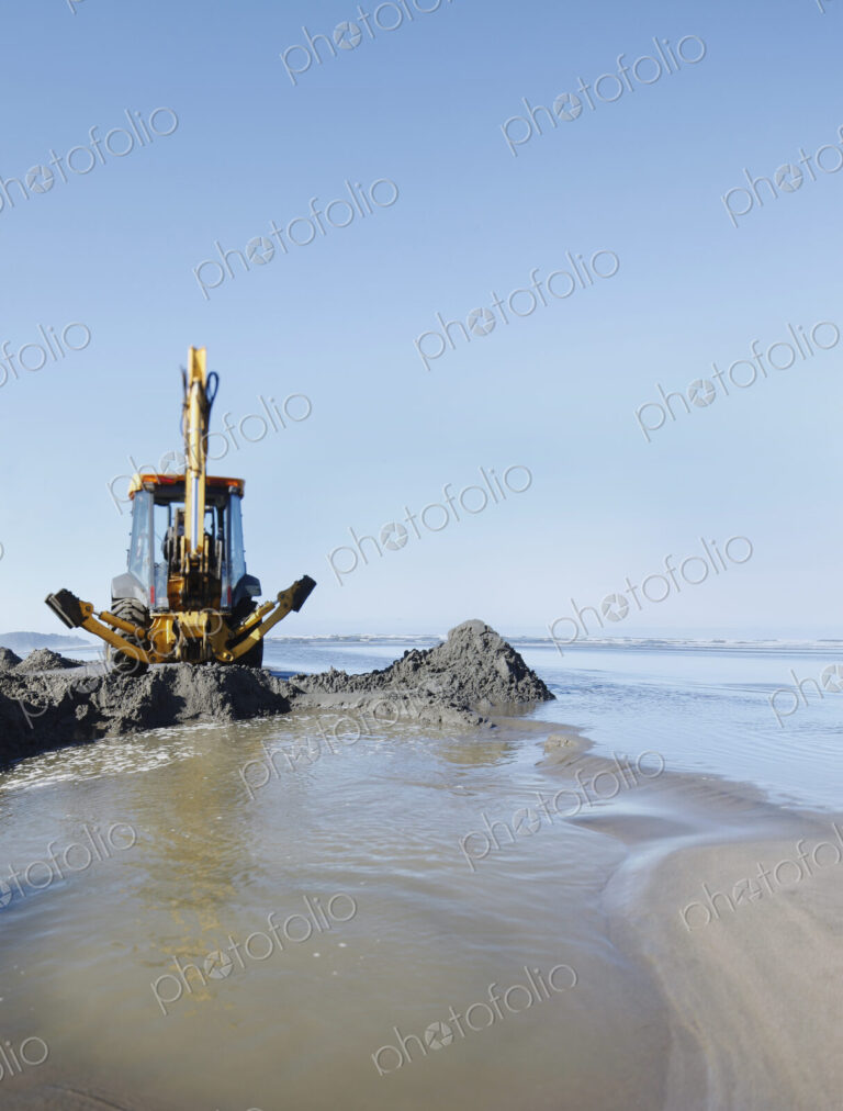 Backhoe,digger,machinery,digging,scoop,tractor,soft sand,sand,wet sand,beach,sandy…