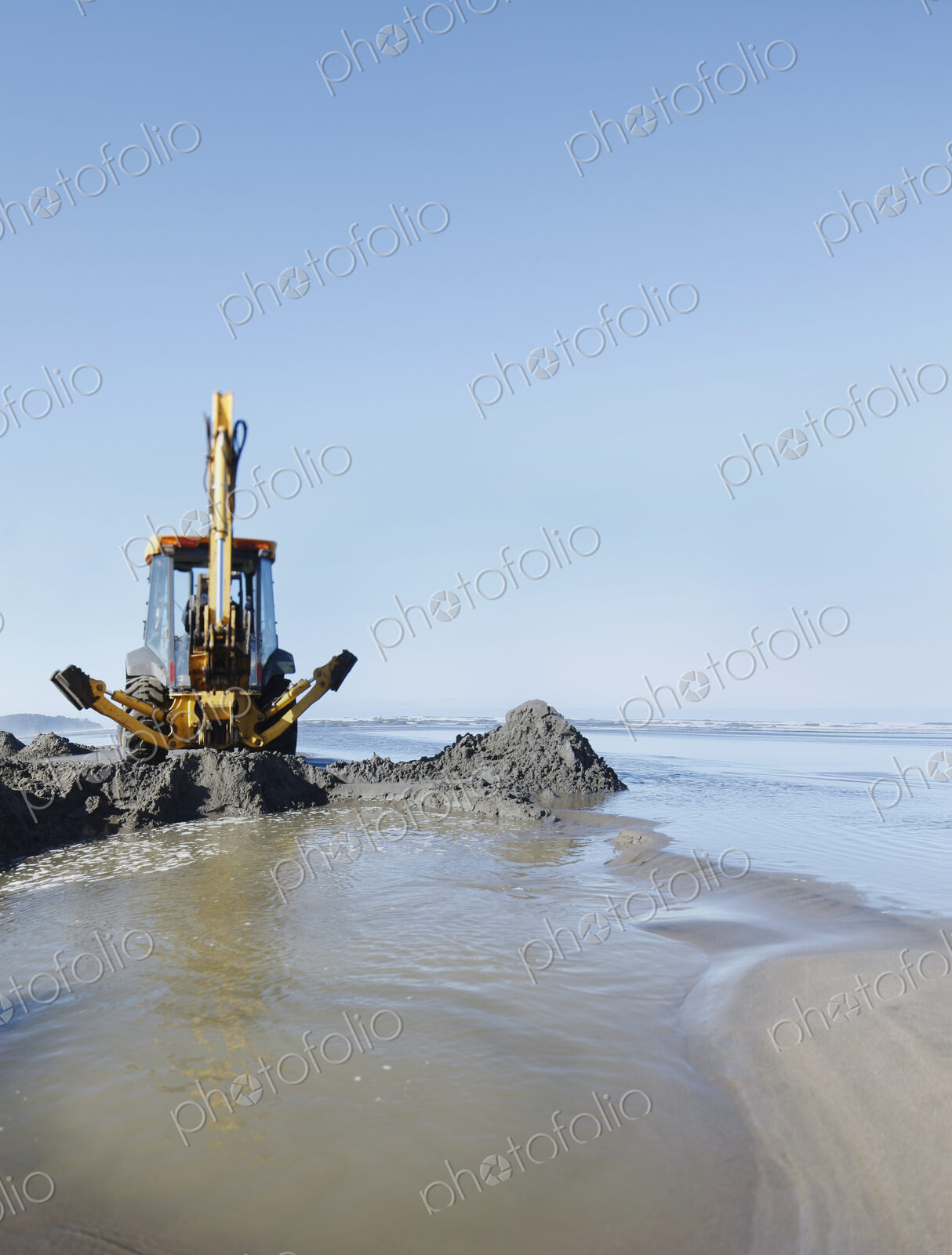 Backhoe,digger,machinery,digging,scoop,tractor,soft sand,sand,wet sand,beach,sandy…