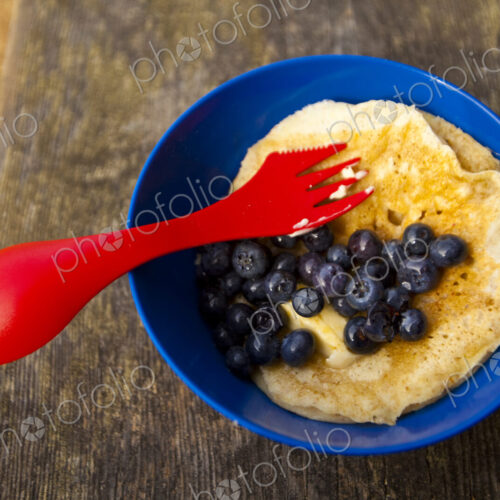 Backpacker's breakfast, Blake Island, a plastic plate and fork, eggs and blueberries. Backpacker's breakfast, Blake Island, a plastic plate and fork, eggs and blueberries.