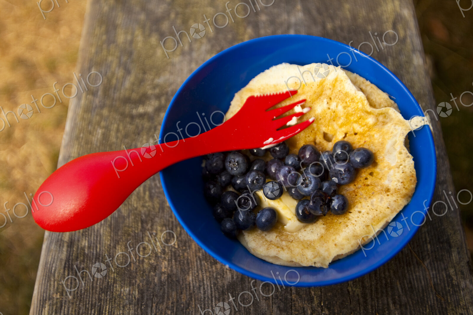 Backpacker’s breakfast, Blake Island, a plastic plate and fork, eggs and blueberries.