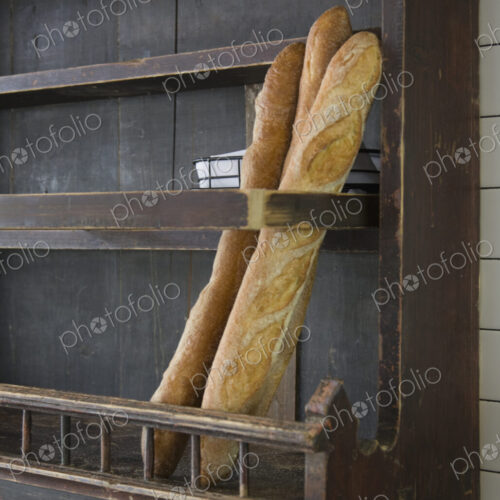 Baguettes in wooden wall rack at a restaurant. Baguettes in wooden wall rack at a restaurant.