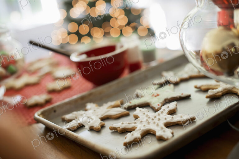 Baking tray of organic homemade Christmas cookies in the shapes of icicles and stars.