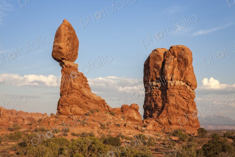 Balanced Rock glows in the warm light of sunset in Arches National Park, Utah,…