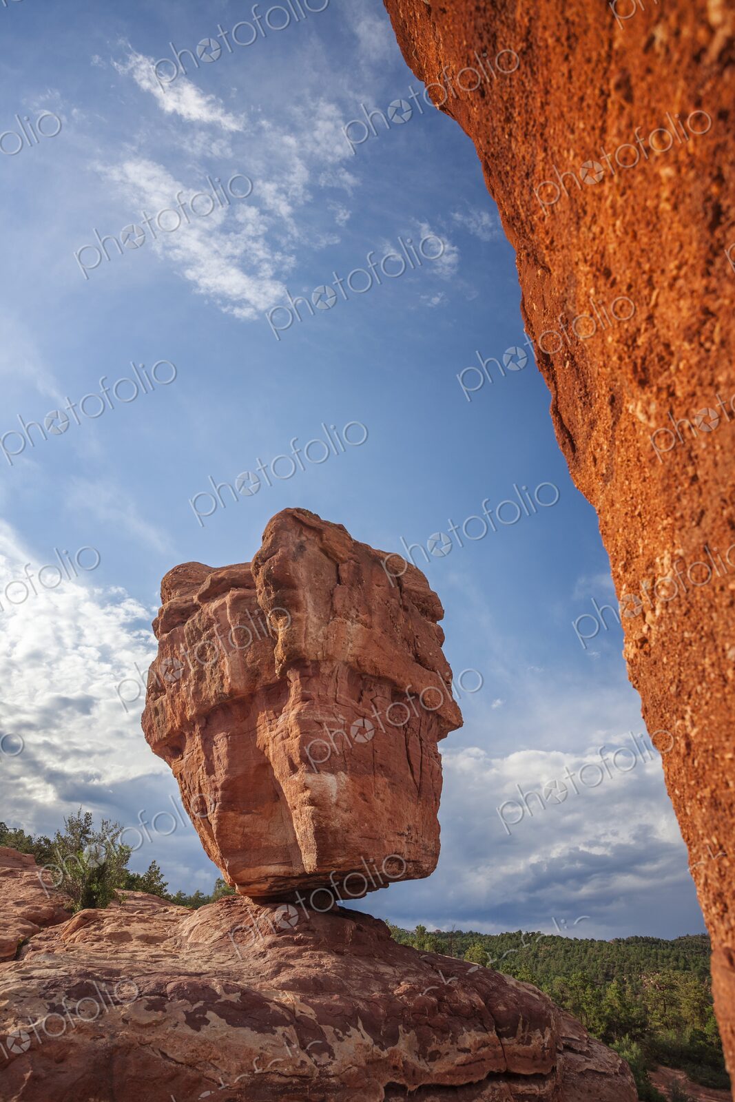 Balanced Rock rises from red sandstone in Garden of the Gods, Colorado Springs, framed…