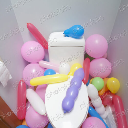 Balloons in a Bathroom surrounding a toilet Balloons in a Bathroom surrounding a toilet