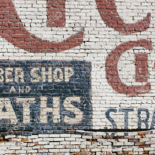 "Barber Shop & Baths" sign painted on old old brick wall "Barber Shop & Baths" sign painted on old old brick wall