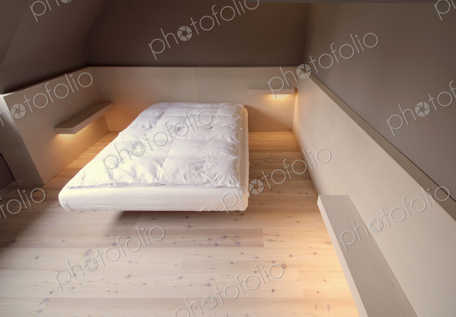 Bare mattress and empty shelves in modern bedroom
