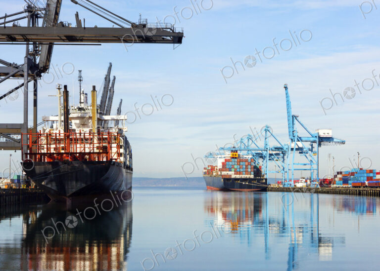 Barges with containers in industrial shipyard