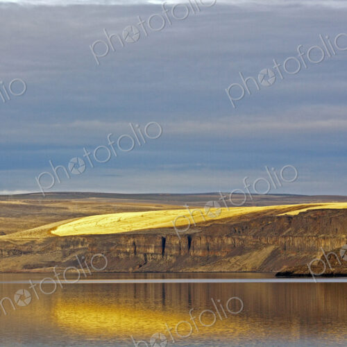 Barren Cliff Face Reflected in Water Barren Cliff Face Reflected in Water