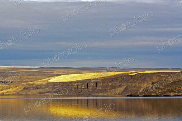 Barren Cliff Face Reflected in Water