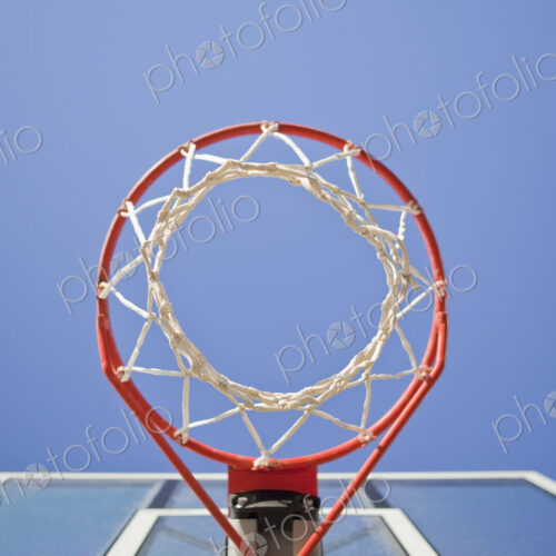 Basketball hoop, metal ring and netting, view from underneath.