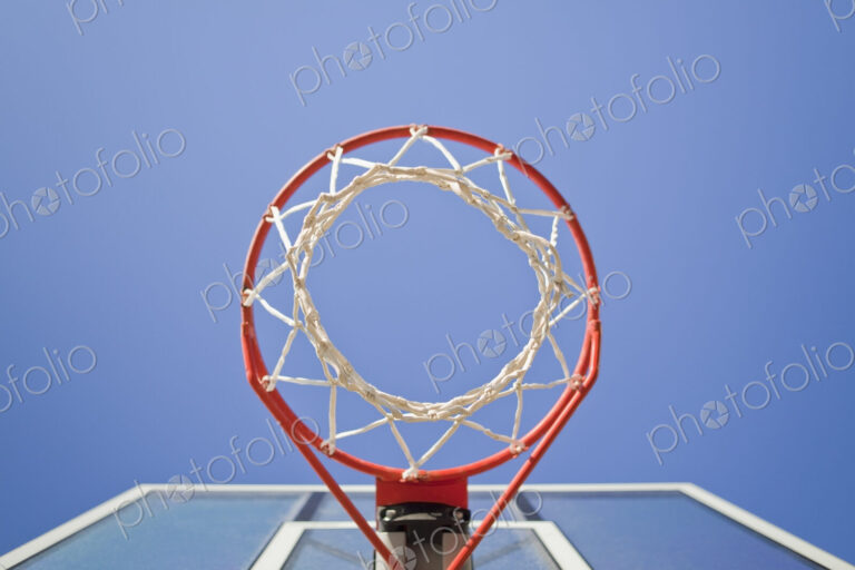 Basketball hoop, metal ring and netting, view from underneath.