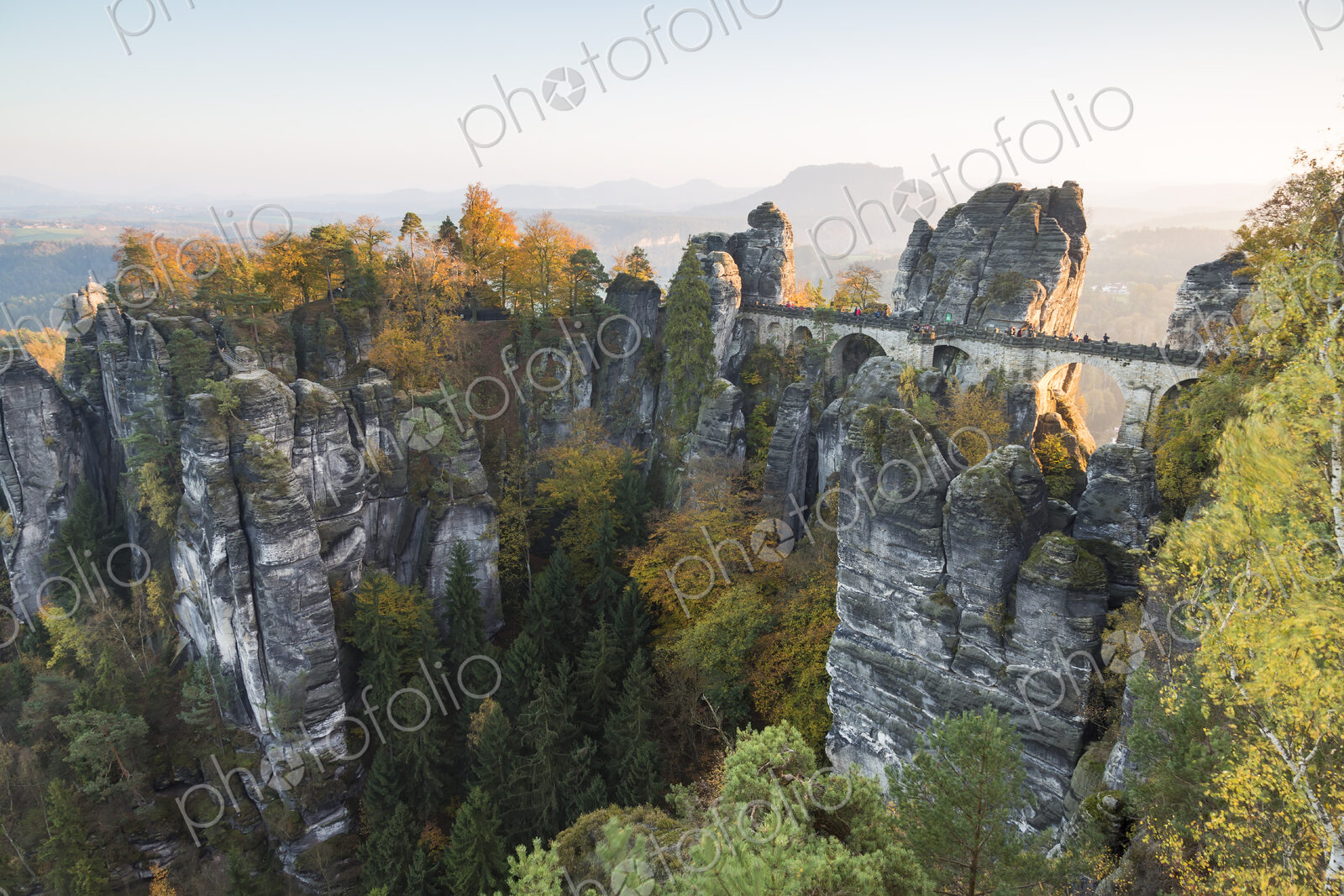 Bastei rock formation above the Elbe River with bridge linking several rocks.