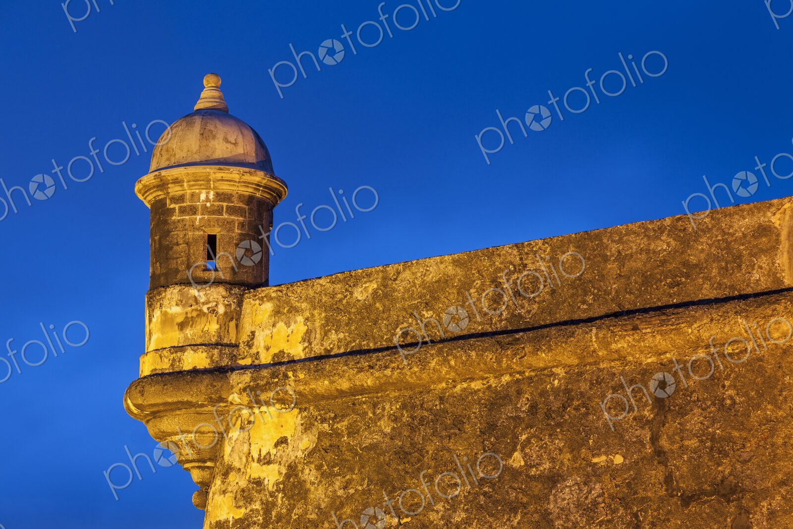 Bathed in warm light against the vivid blue twilight sky, this historic garita-or…