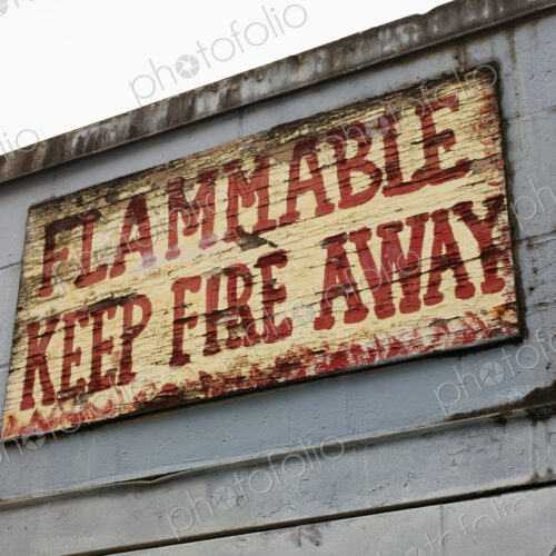 Battered warning sign on building, Seattle, Washington, USA