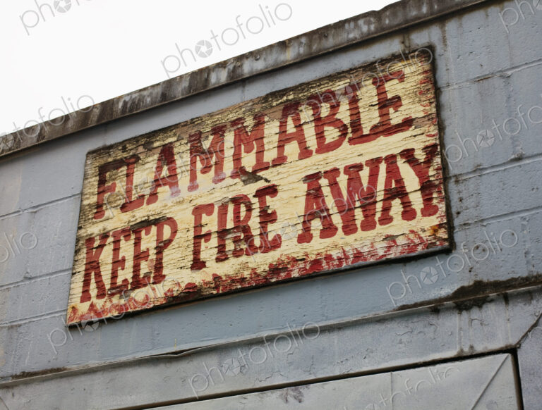 Battered warning sign on building, Seattle, Washington, USA
