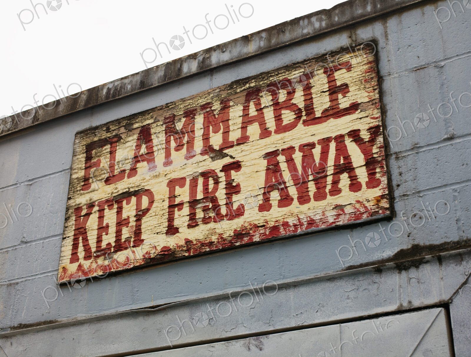 Battered warning sign on building, Seattle, Washington, USA